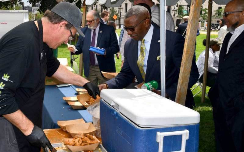 Michigan legislator is served pan-seared whitefish provided by Big Stone Bay Fisheries